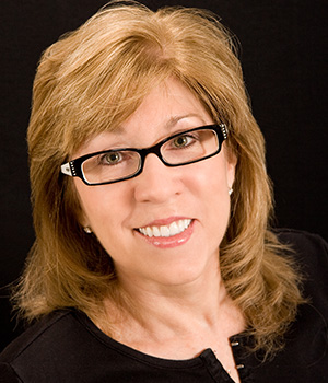 woman with glasses smiling