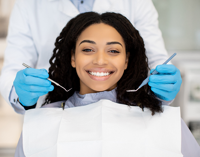 Woman in the dental chair grinning during a checkup