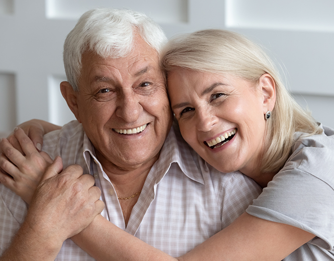 Senior couple smiling and embracing