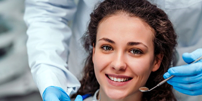 woman smiling at emergency dentist in Windermere 