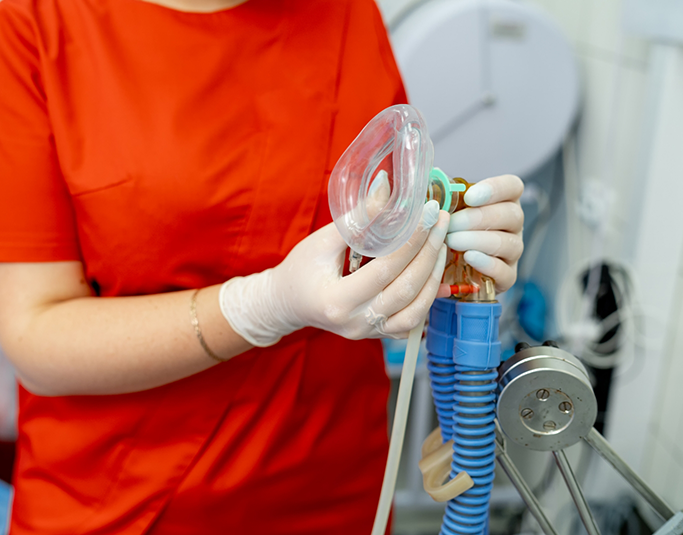 Sedation dentist holding a nasal mask for nitrous oxide sedation
