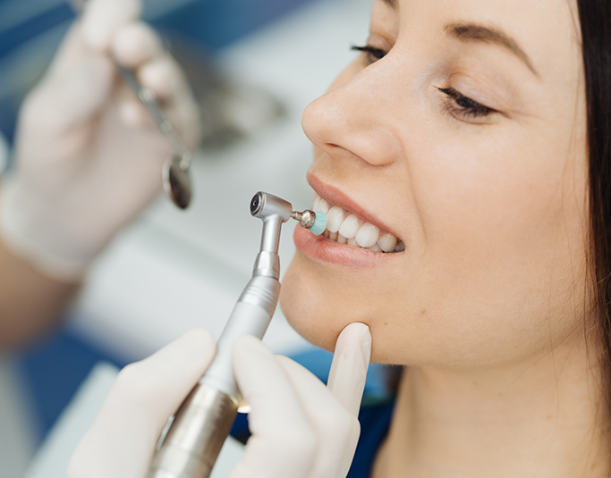 Woman in the dental chair getting a professional teeth cleaning
