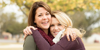 A mother and daughter hugging.