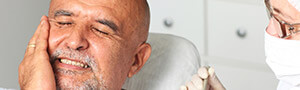 man holding jaw in pain