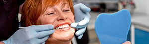 woman looking at smile with dentist