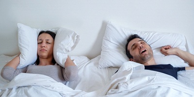 Woman and snoring man