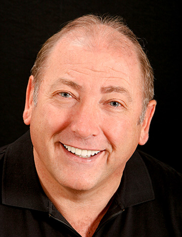 Older man grinning with whiter and straighter teeth