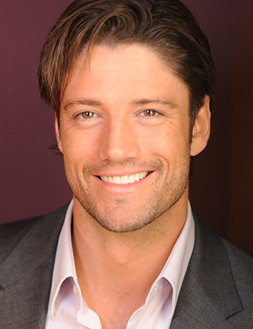 Man with long brown hair smiling with whiter teeth