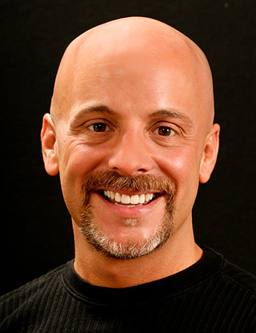 Bald man smiling with whiter and straighter teeth