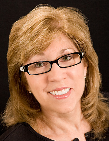 Blonde woman smiling after whitening her teeth
