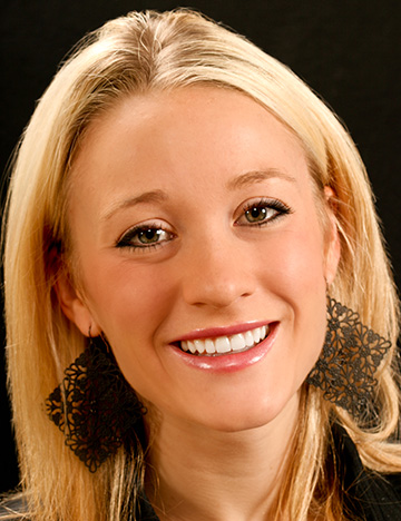 Young woman grinning with whiter and more evenly aligned teeth