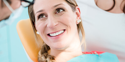 woman smiling directly at dentist