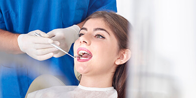 dentist checking woman's smile