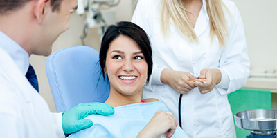 woman talking to dental team