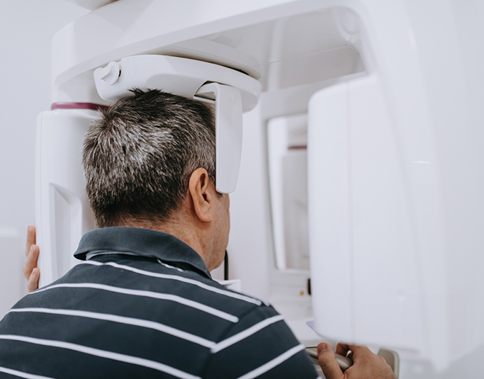 Dental patient getting a cone beam scan of his mouth and jaws