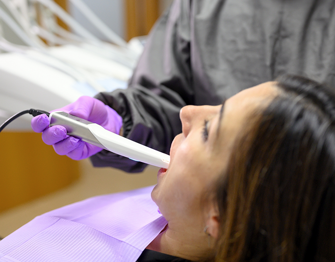 Woman having her dentist take digital impressions of her teeth