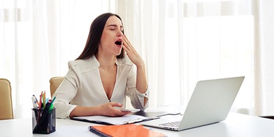 woman yawning at work 