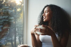 Woman enjoying coffee safely during Invisalign treatment