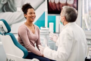 Woman smiling while at her dental implant consultation