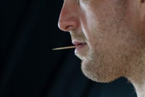 Man chewing on toothpick. 