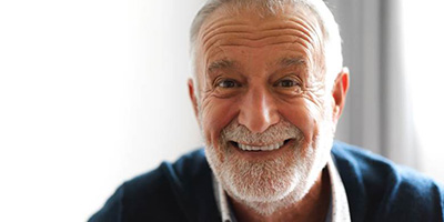 Senior man in blue shirt with dentures in Windermere, FL