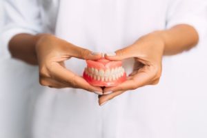 Person holding dentures