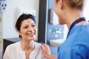 A patient smiling during her dental checkup