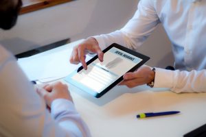 Patient reviewing dental insurance forms on tablet