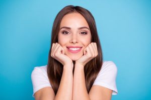 A woman smiling after her cosmetic dentistry treatments