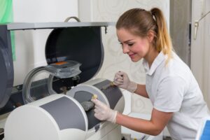 Dentist putting ceramic into CEREC machine